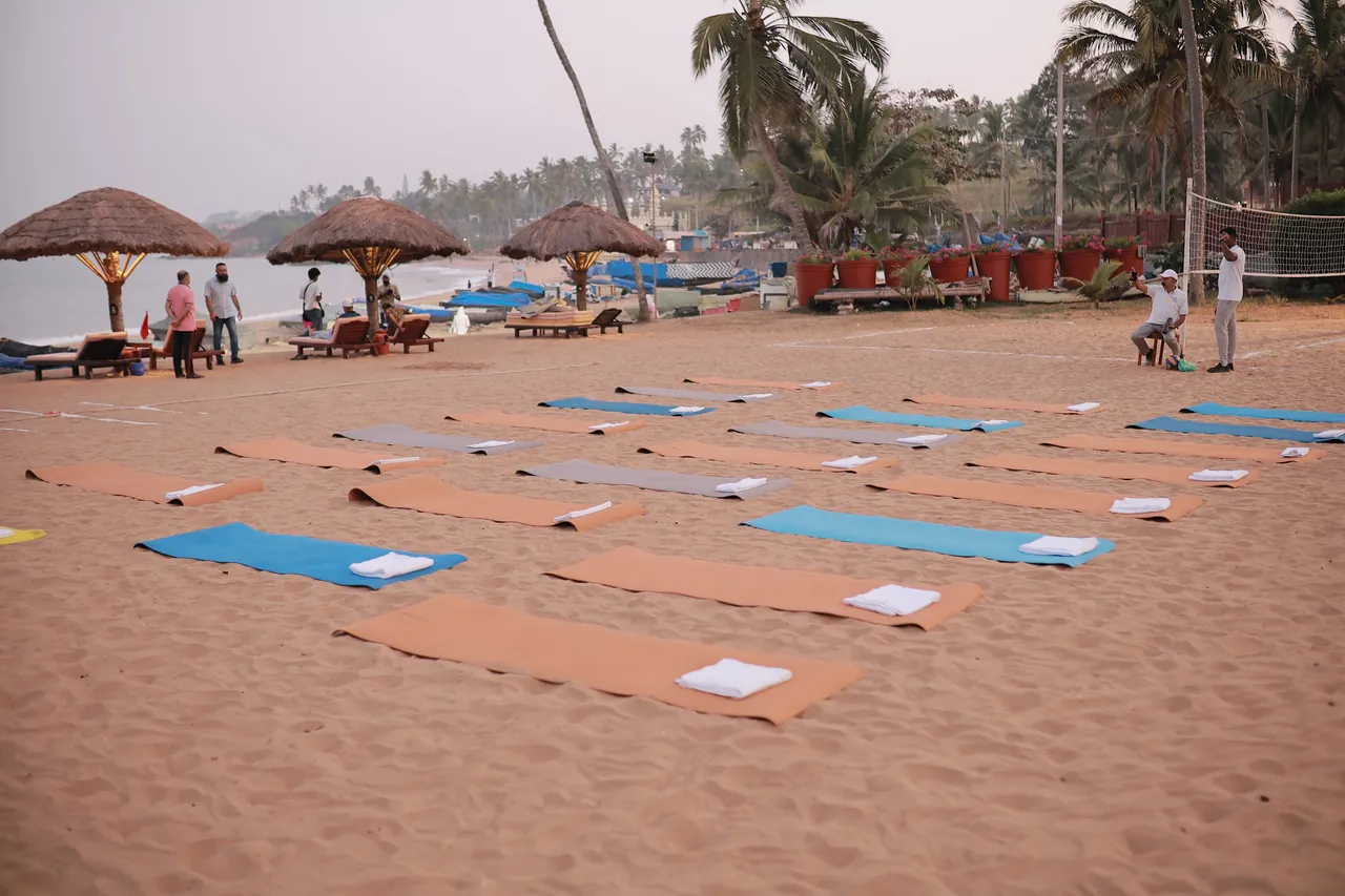 Yoga mats laid out on the sand at Kovalam before a morning session by the sea.