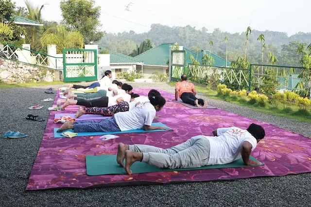 The retreat group practising on mats laid out in the open air at sunrise.