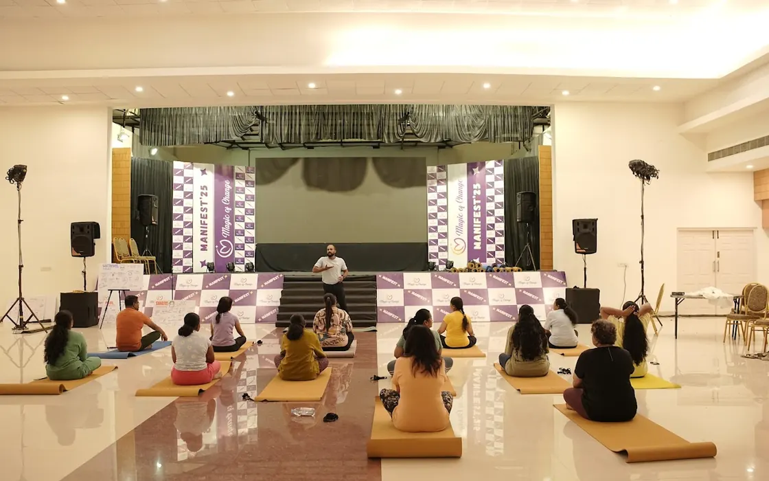 Abhilash leading a seated class from the stage at the Manifest 2025 event.